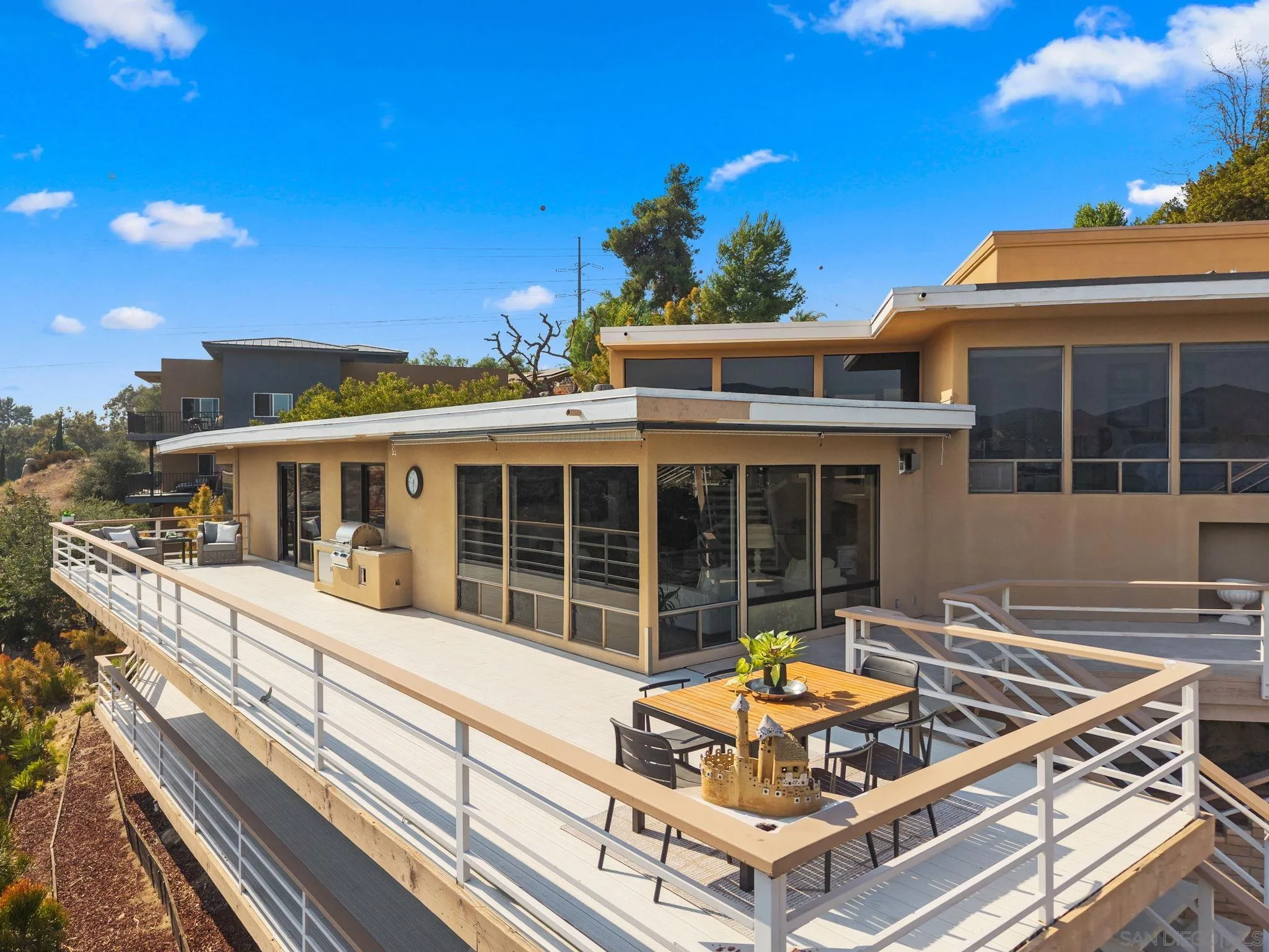 2552 Singing Vista Way El Cajon, CA 92019 - Photo 3 of 34 a view of a house with a large window and balcony