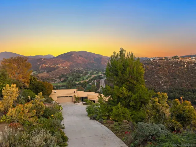 an aerial view of a house with mountain view