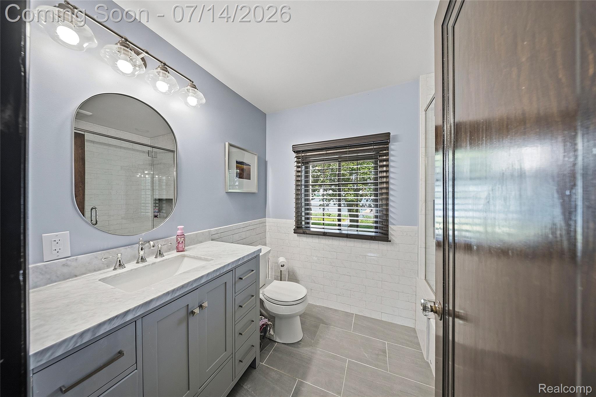 18460 Meridian Road Grosse Ile, MI 48138 - Photo 30 of 50 Vanity with a light-toned countertop, an undermount sink, and brushed nickel fixtures