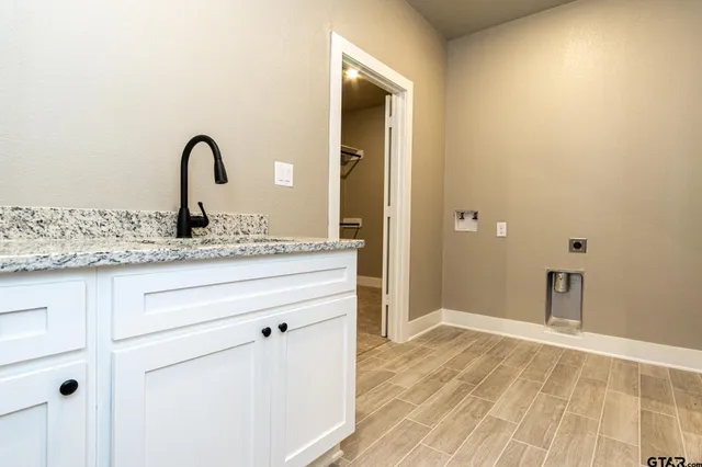 a bathroom with a granite countertop toilet sink and mirror