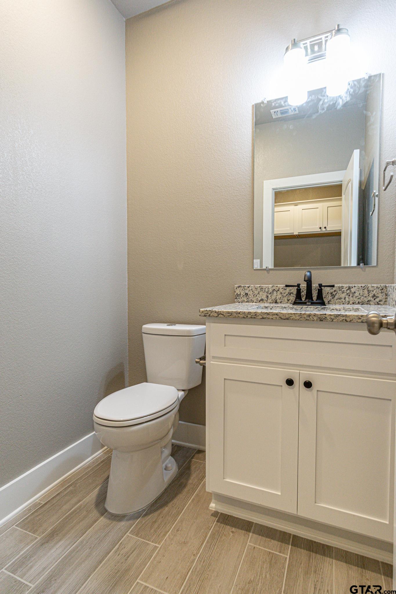 122 Pr 6305 Mineola Tx 75773 Mineola, TX 75773 - Photo 15 of 28 a bathroom with a granite countertop toilet sink and mirror