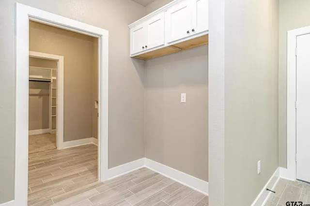 a view of a hallway with wooden floor