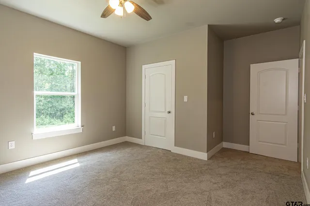 a bathroom with a granite countertop sink toilet and mirror