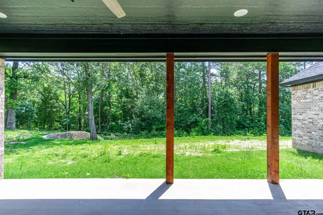 a front view of a house with a garden and yard