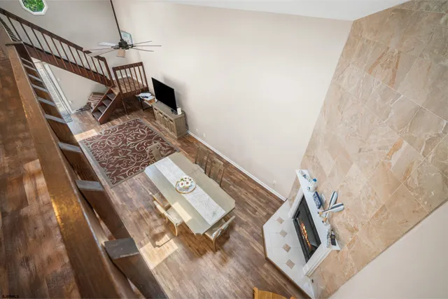 a view of a hallway with wooden floor and staircase