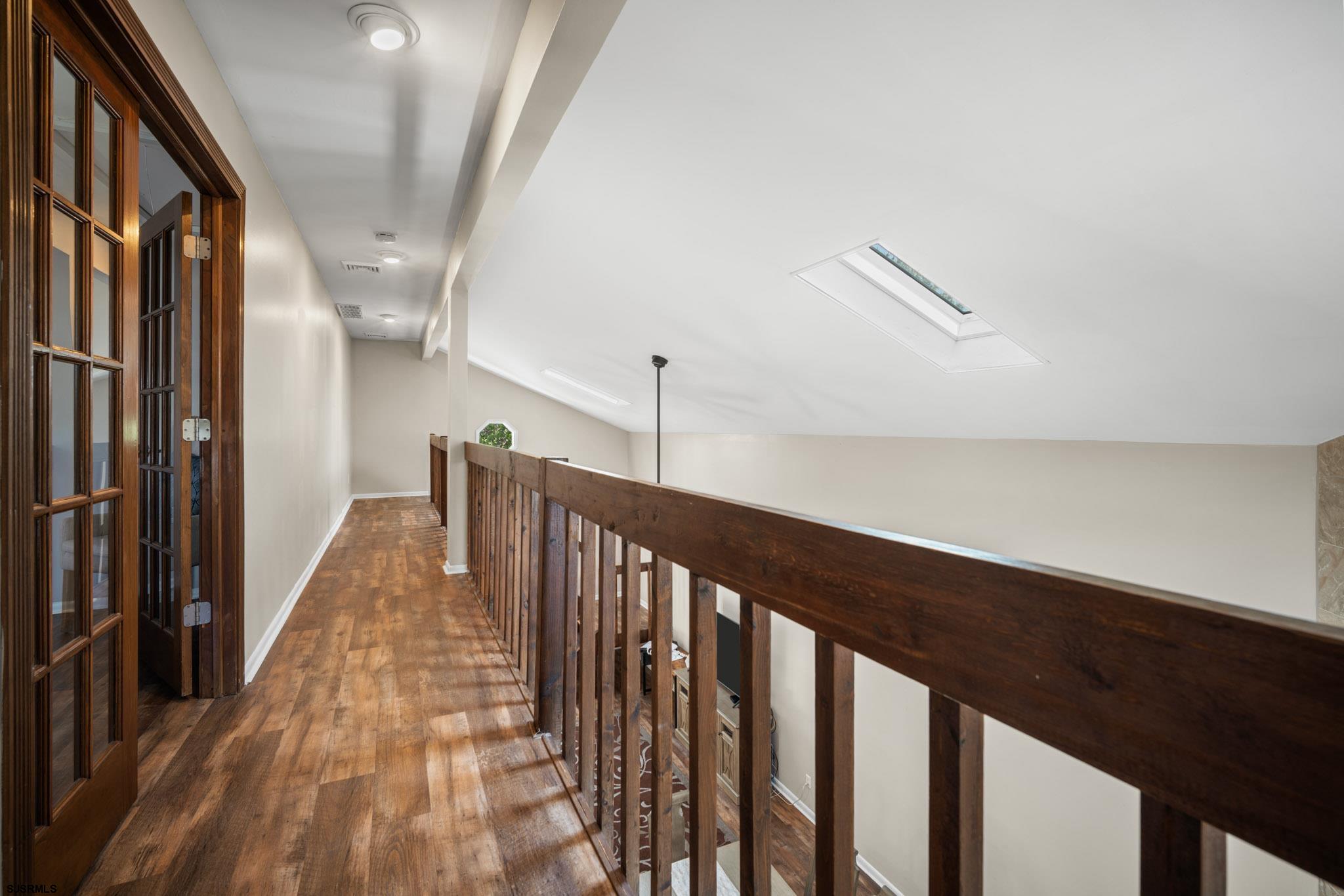10 Explorer Road Brigantine, NJ 08203 - Photo 16 of 39 a view of a hallway with wooden floor and staircase