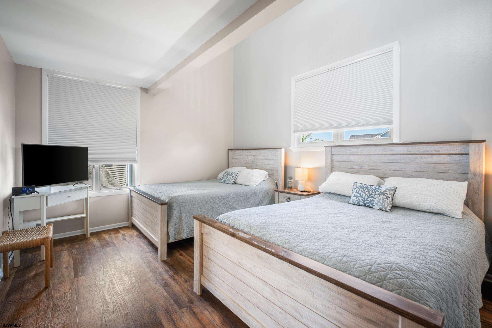 10 Explorer Road Brigantine, NJ 08203 - Photo 18 of 39 a bedroom with two beds and a flat screen tv