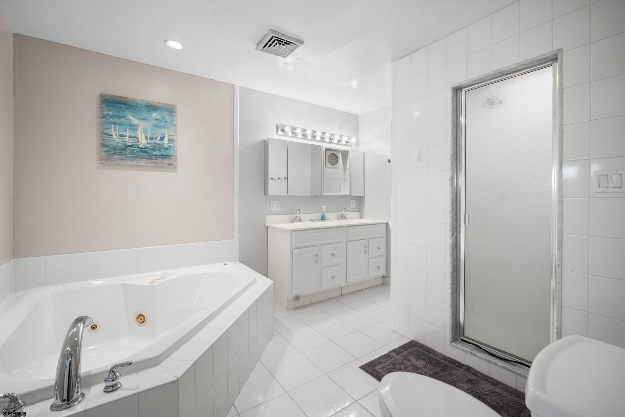 10 Explorer Road Brigantine, NJ 08203 - Photo 20 of 39 a bathroom with a sink a toilet and shower