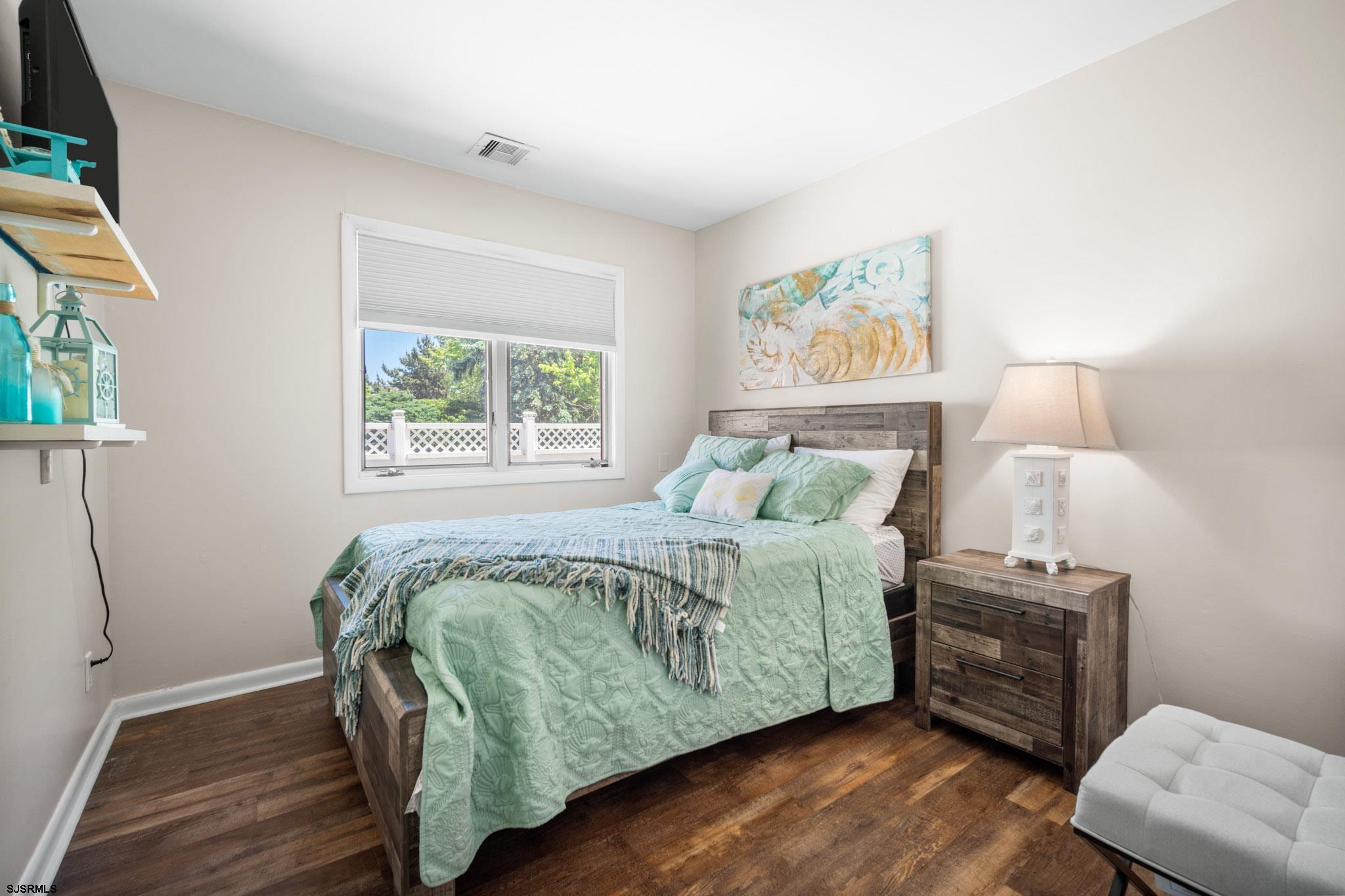 10 Explorer Road Brigantine, NJ 08203 - Photo 23 of 39 a bedroom with a bed and a window