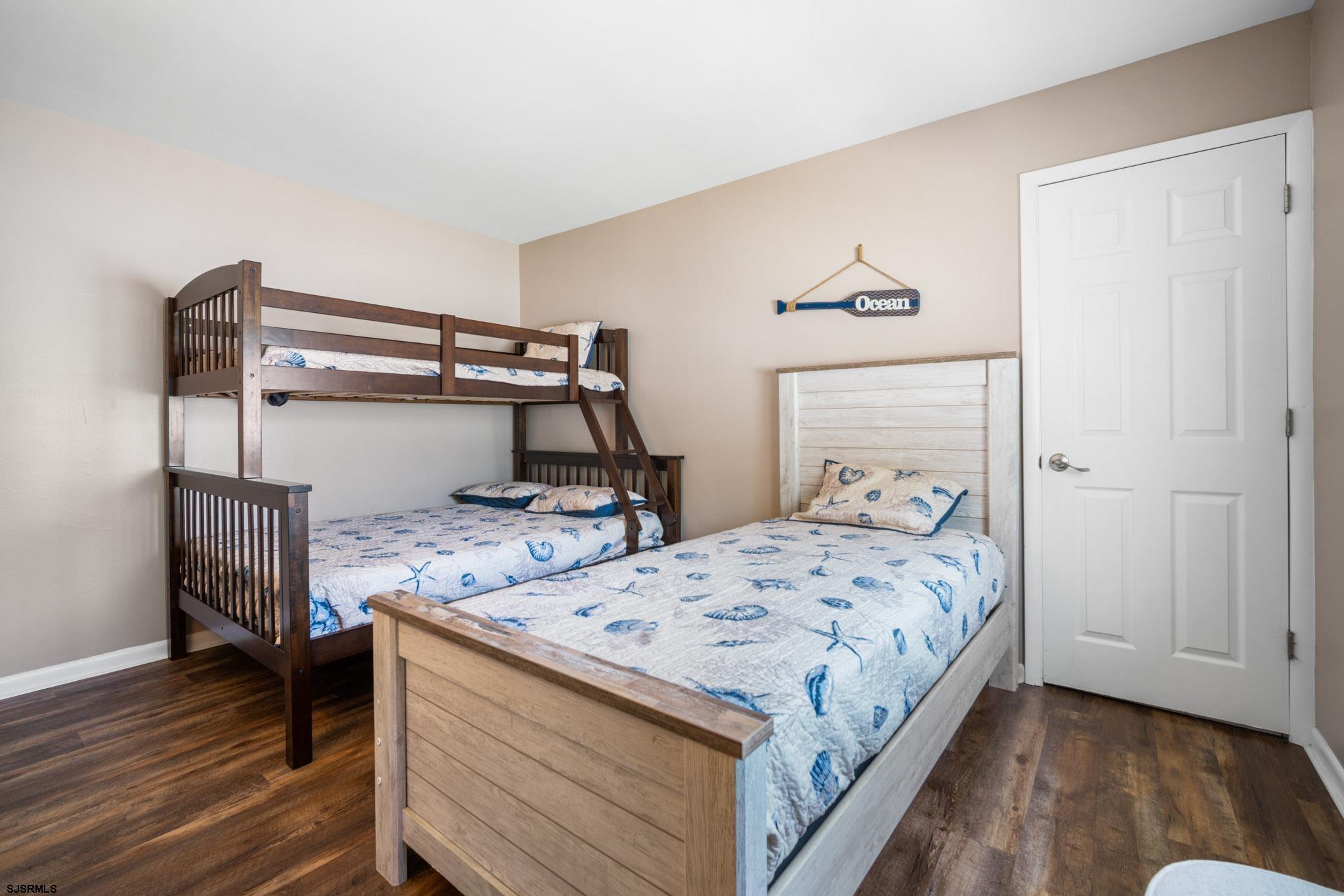 10 Explorer Road Brigantine, NJ 08203 - Photo 25 of 39 a bedroom with a bed and wooden floor