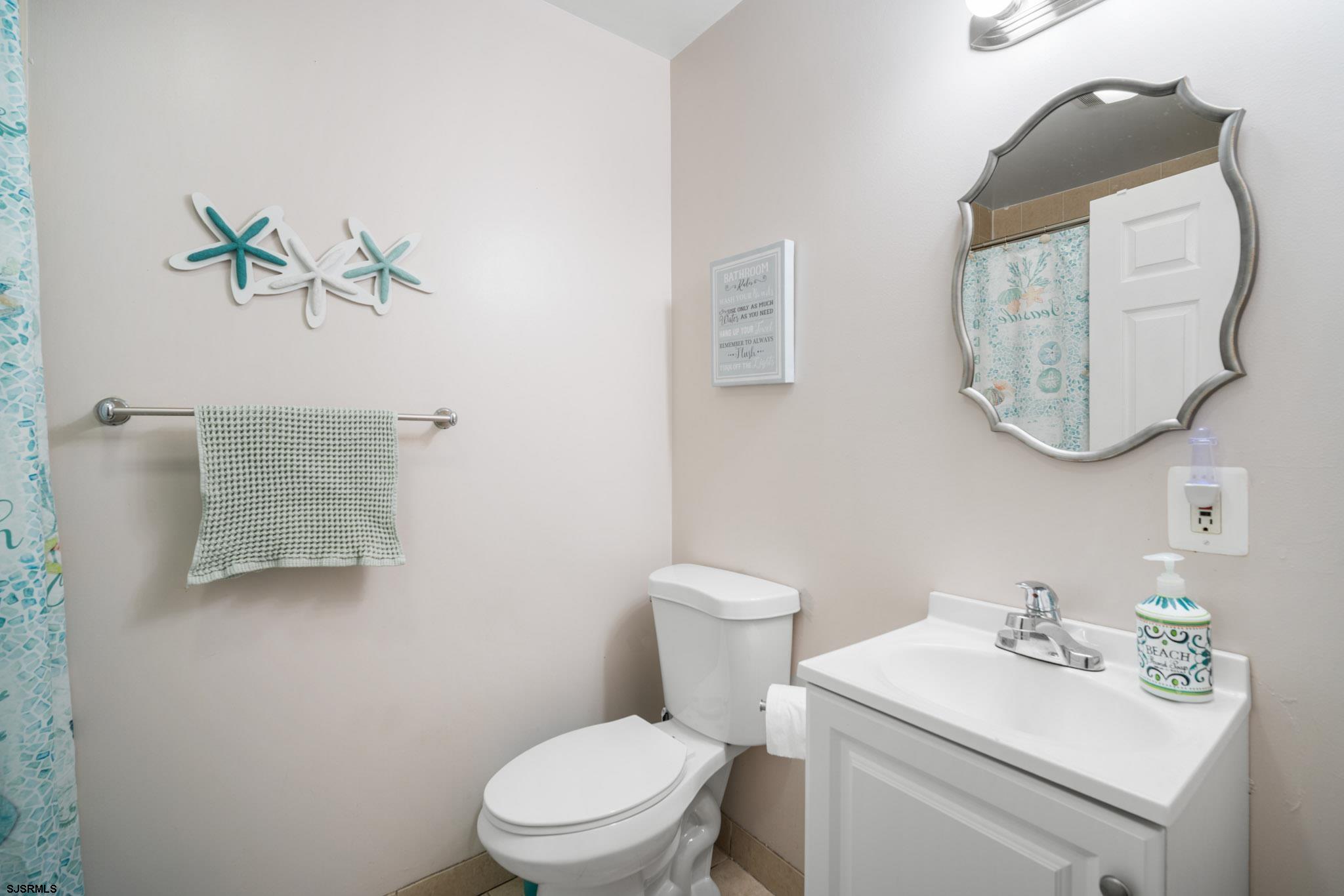 10 Explorer Road Brigantine, NJ 08203 - Photo 29 of 39 a white toilet sitting next to a bathroom sink