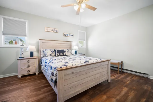 a bedroom with a bed and a flat tv screen on dresser