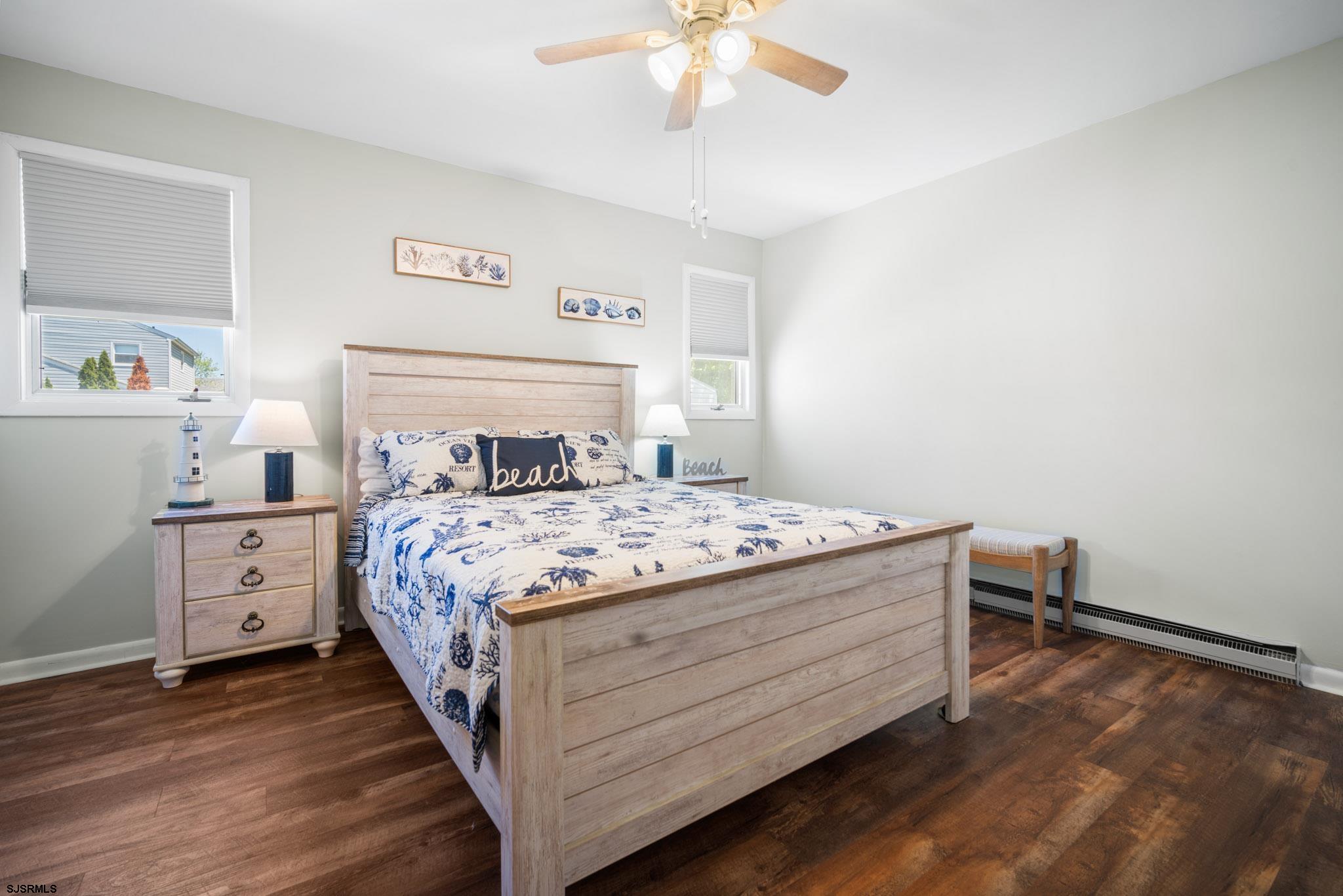 10 Explorer Road Brigantine, NJ 08203 - Photo 30 of 39 a bedroom with a bed and a chandelier