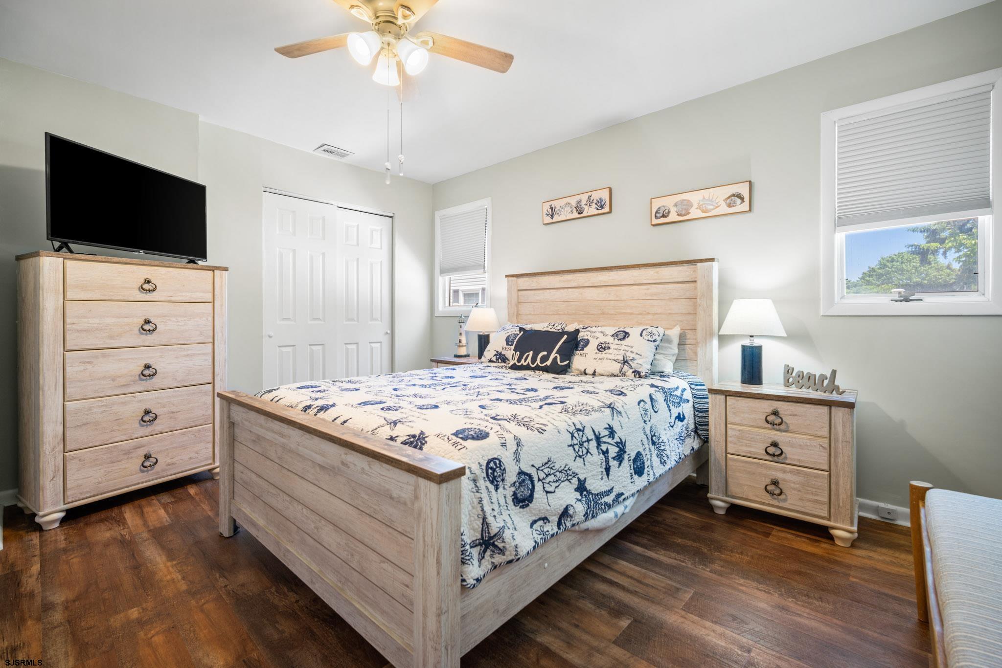 10 Explorer Road Brigantine, NJ 08203 - Photo 31 of 39 a bedroom with a bed and a flat tv screen on dresser