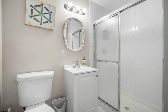 a view of a patio with table and chairs with plants and wooden fence