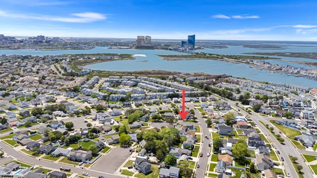 an aerial view of a house with a garden and lake view