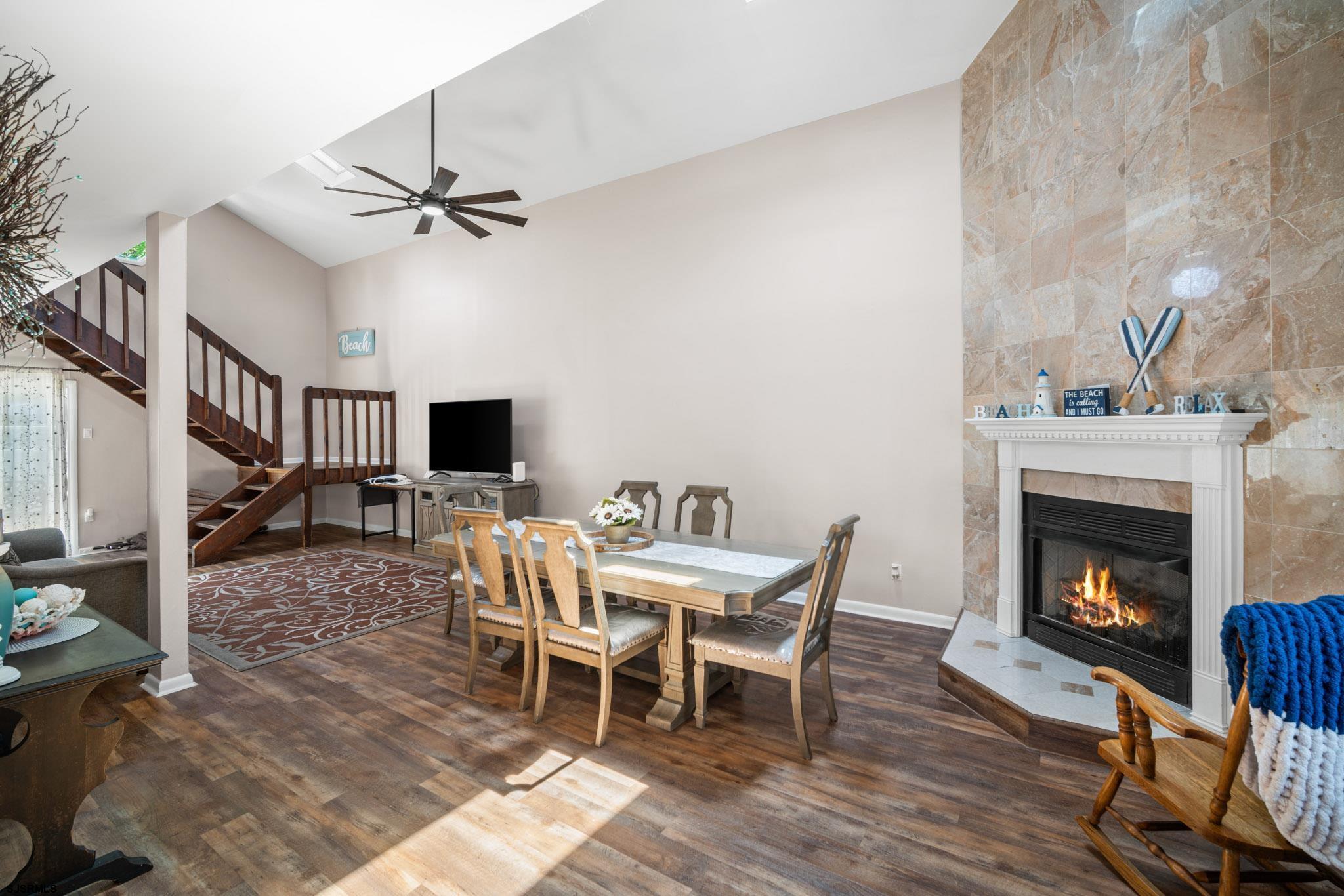 10 Explorer Road Brigantine, NJ 08203 - Photo 9 of 39 a dining room with furniture a fireplace and wooden floor