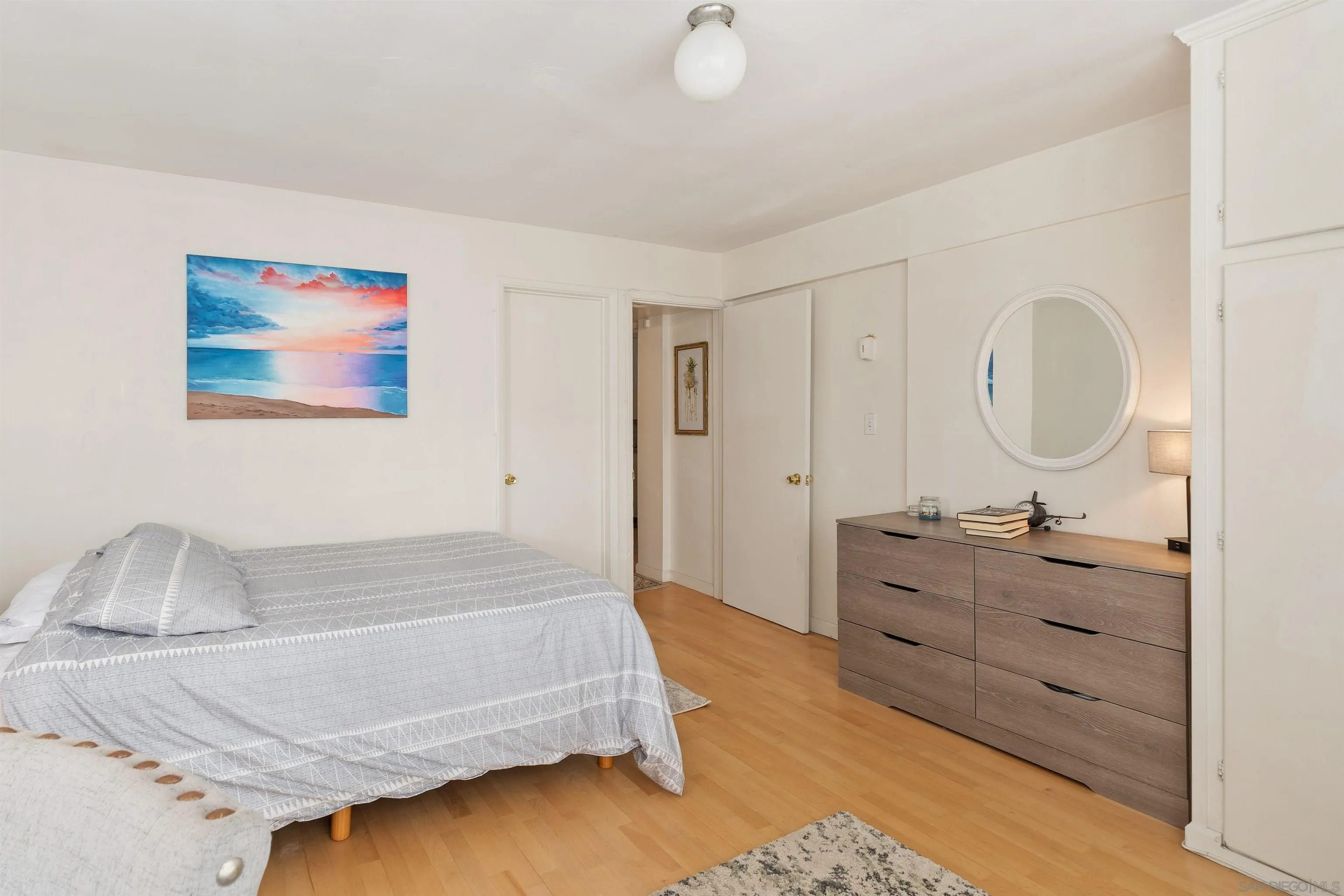 8040 Girard Avenue, Unit 2 La Jolla, CA 92037 - Photo 12 of 17 a bedroom with a bed and a dresser