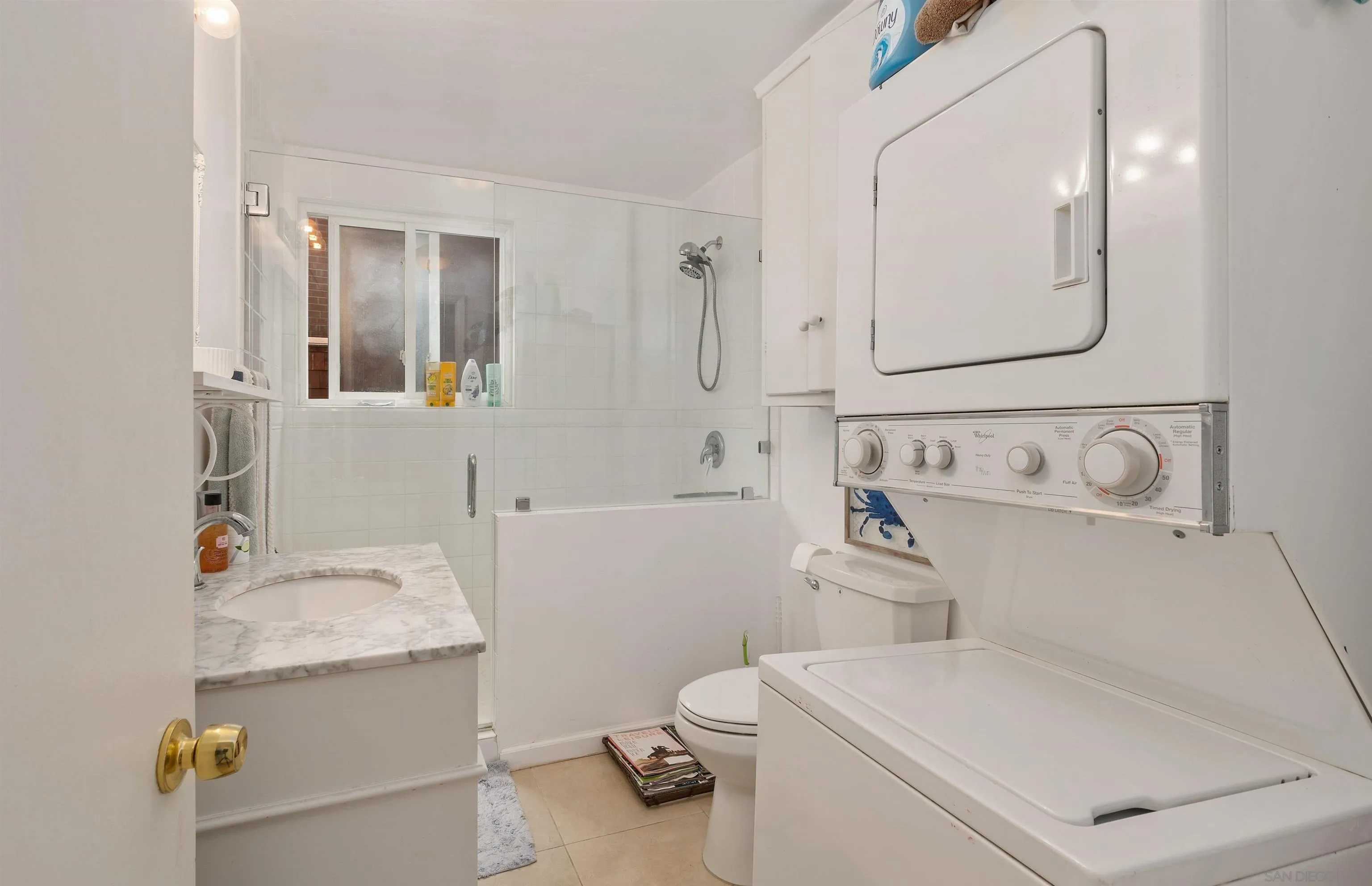 8040 Girard Avenue, Unit 2 La Jolla, CA 92037 - Photo 13 of 17 a bathroom with a sink toilet and shower