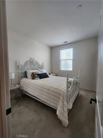 a bedroom with a bed and window