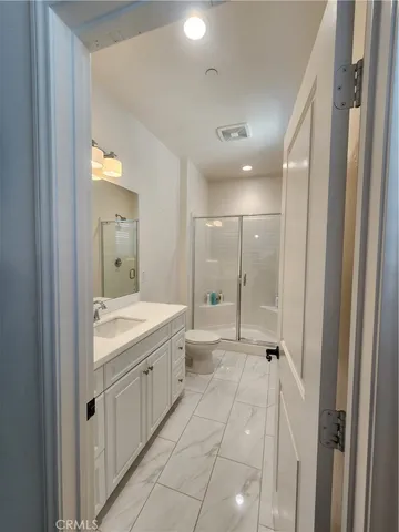 a bathroom with a granite countertop sink mirror and a bathtub