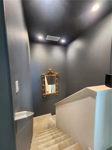 a bedroom with a bed and a mirror