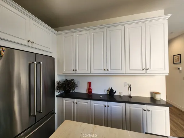 a kitchen with stainless steel appliances granite countertop a refrigerator sink and cabinets