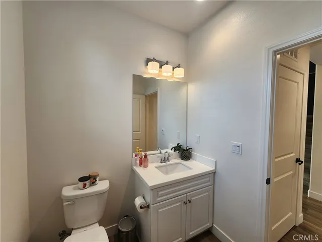 a bathroom with a sink vanity mirror and toilet