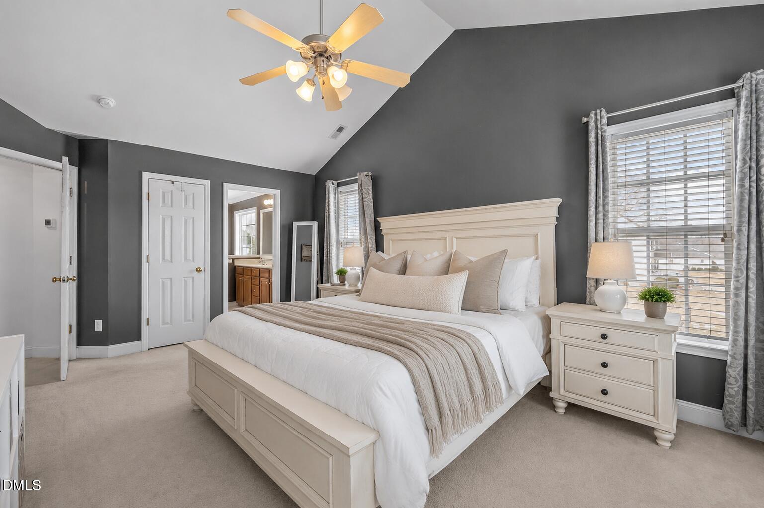 51 Water Front Lane Timberlake, NC 27583 - Photo 16 of 29 a spacious bedroom with a bed a chandelier and a large window