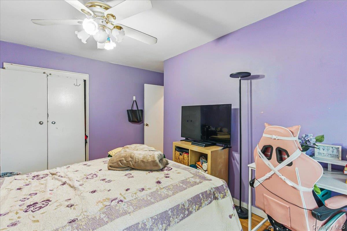 209-80 18th Avenue, Unit 4D Queens, NY 11360 - Photo 11 of 18 Bedroom featuring ceiling fan, a closet, and wood finished floors