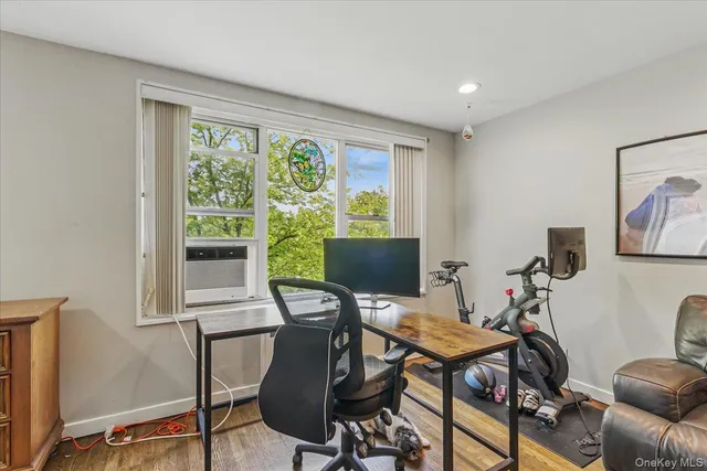 a view of a workspace with furniture and a window