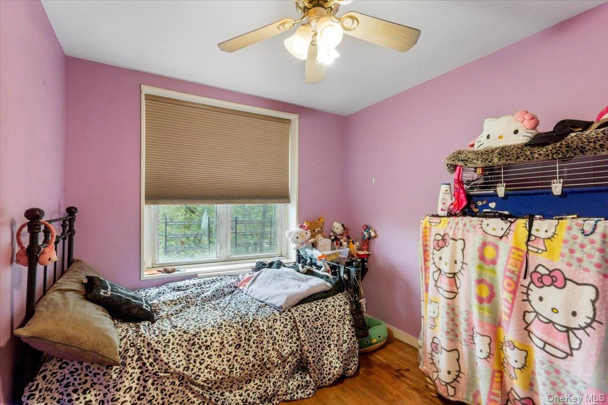 209-80 18th Avenue, Unit 4D Queens, NY 11360 - Photo 17 of 18 Bedroom featuring wood finished floors and ceiling fan