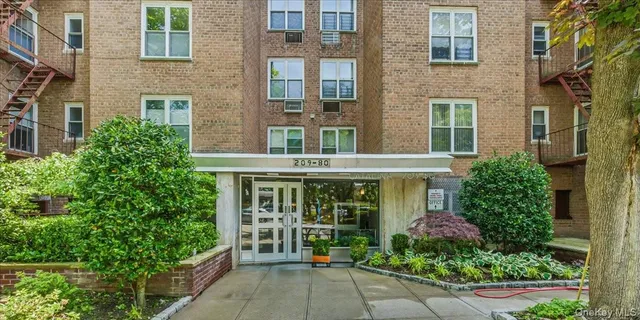 front view of a brick house with a large window
