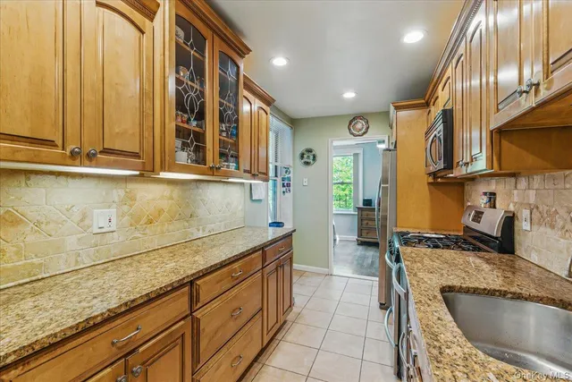 a kitchen with stainless steel appliances granite countertop a sink and a granite counter tops