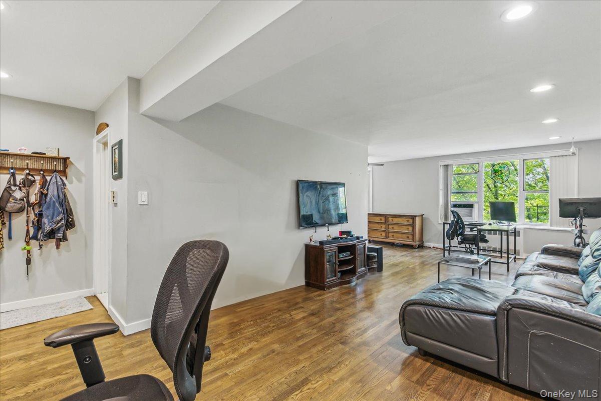 209-80 18th Avenue, Unit 4D Queens, NY 11360 - Photo 8 of 18 Living room with an office area, recessed lighting, and wood finished floors
