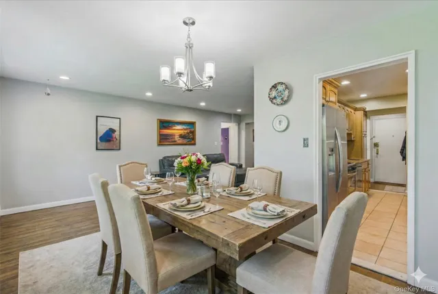 a view of a dining room with furniture wooden floor and a chandelier