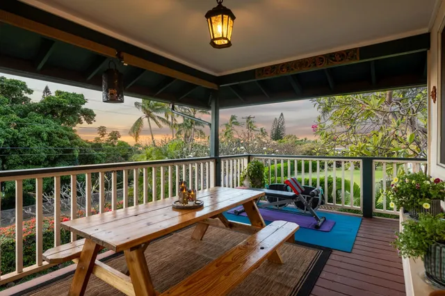 a view of a balcony with chairs and wooden floor