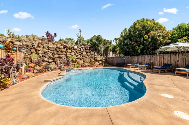 a view of a tables and chairs under an umbrella in patio