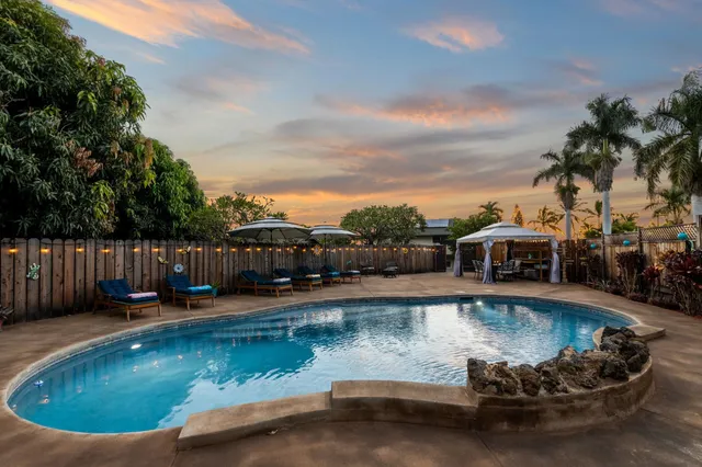 swimming pool view with a seating space and a garden view