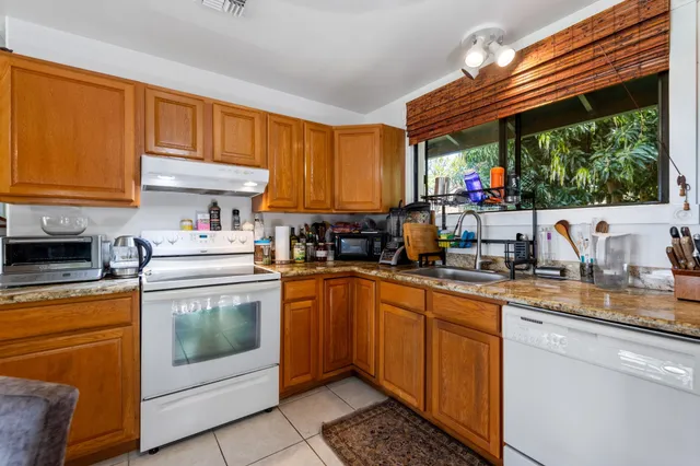 a kitchen with a sink and white cabinets