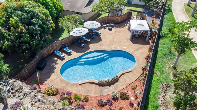 an aerial view of residential house with outdoor space and swimming pool