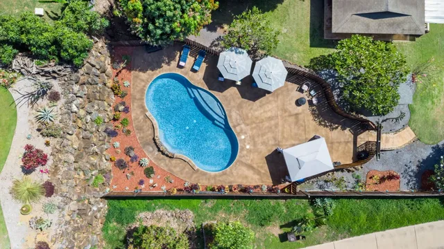 a view of a swimming pool with sitting area