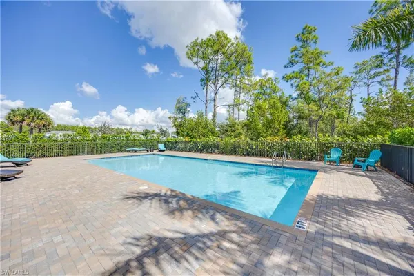 a view of a swimming pool and lounge chair