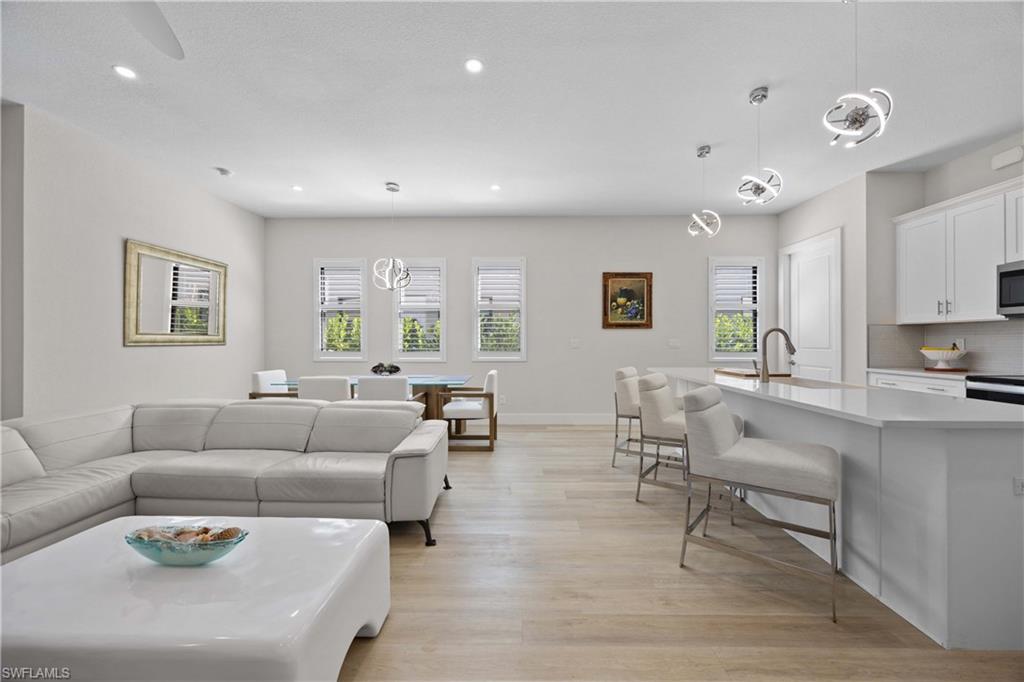 5832 Jasper Way, Unit 5102 Naples, FL 34114 - Photo 11 of 24 a living room with furniture and a large window