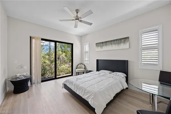 a large bedroom with a bed and a large window
