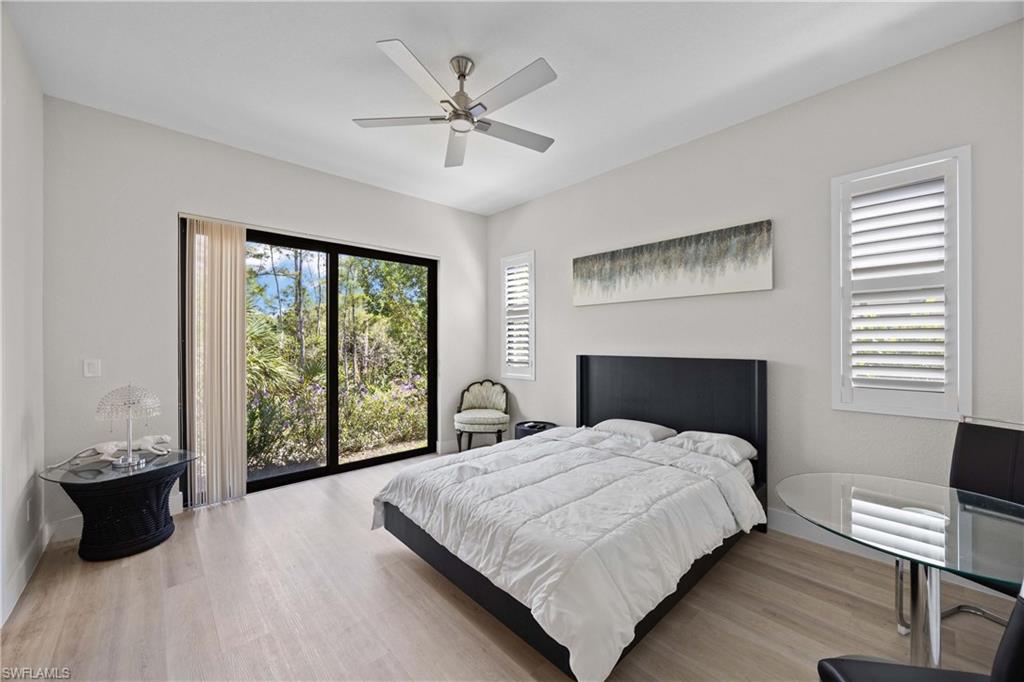 5832 Jasper Way, Unit 5102 Naples, FL 34114 - Photo 14 of 24 a large bedroom with a bed and a large window