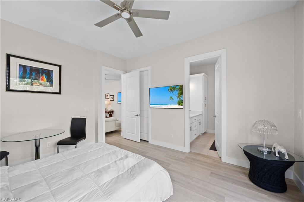 5832 Jasper Way, Unit 5102 Naples, FL 34114 - Photo 16 of 24 a bedroom with a bed and a table