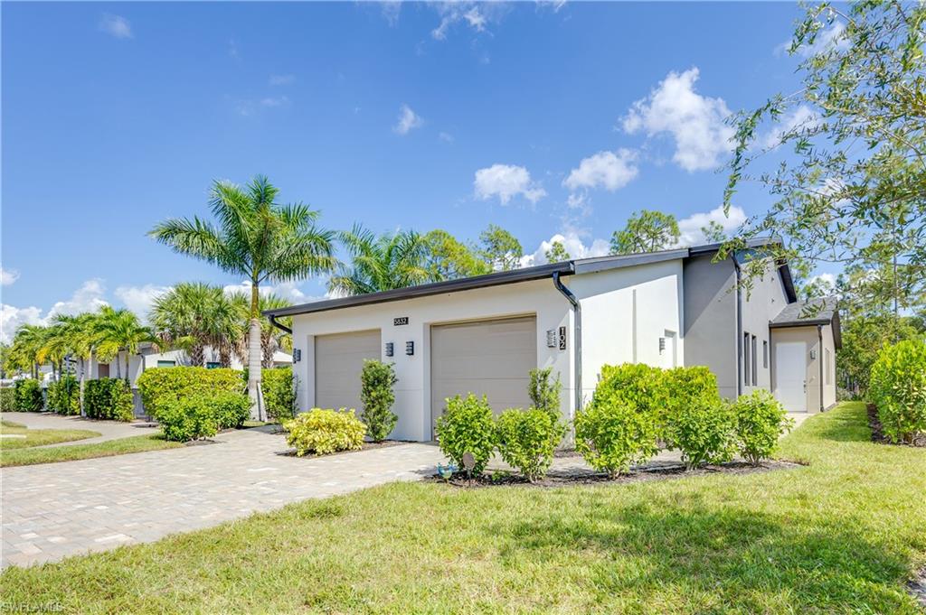 5832 Jasper Way, Unit 5102 Naples, FL 34114 - Photo 23 of 24 a view of a house with a yard and potted plants