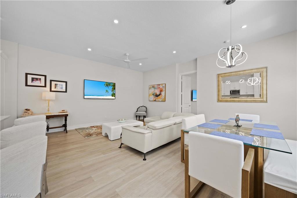 5832 Jasper Way, Unit 5102 Naples, FL 34114 - Photo 9 of 24 a living room with furniture and a table