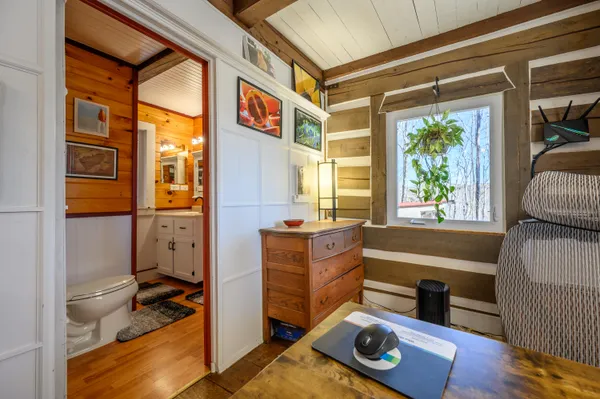 a hallway with a large window and couch